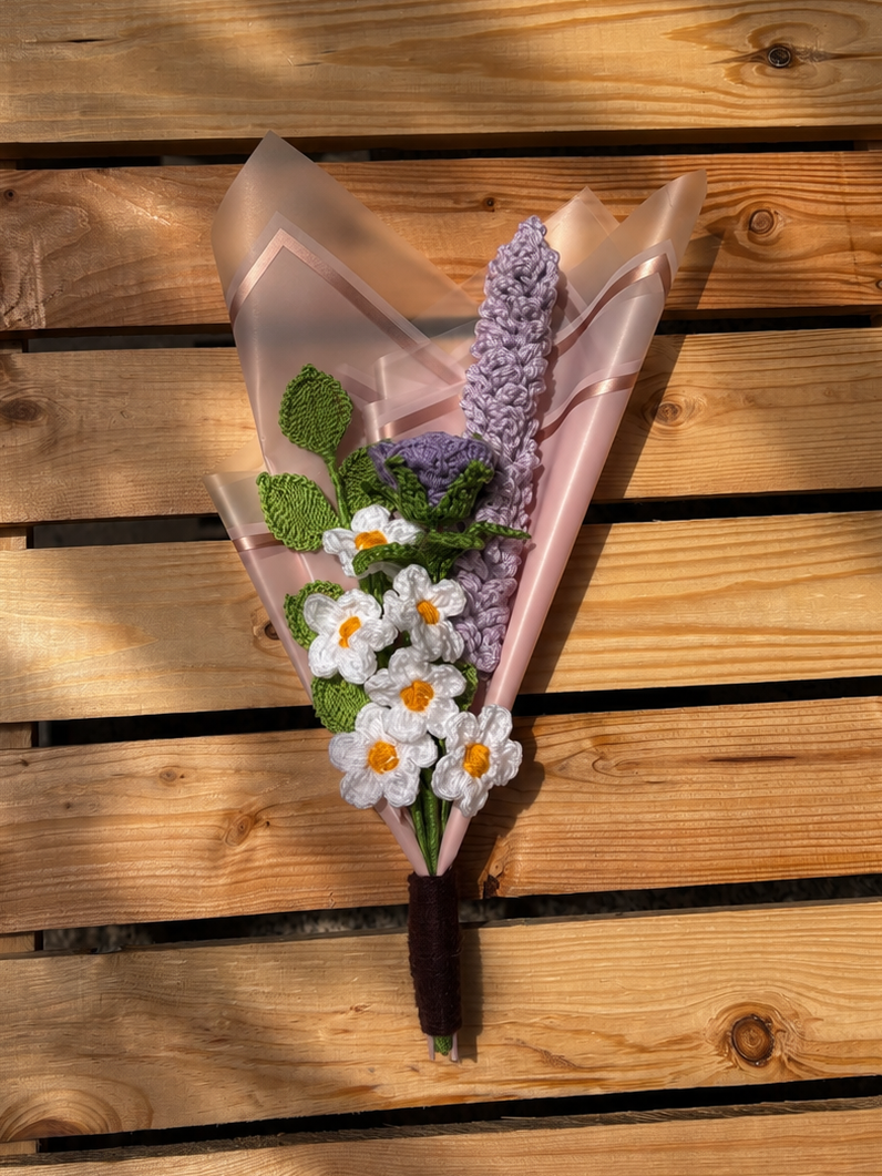 Bouquet of flowers wrapped in brown paper on a wooden surface
