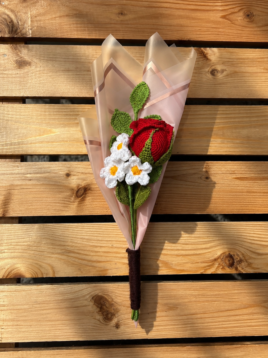 Bouquet of flowers wrapped in brown paper on a wooden surface