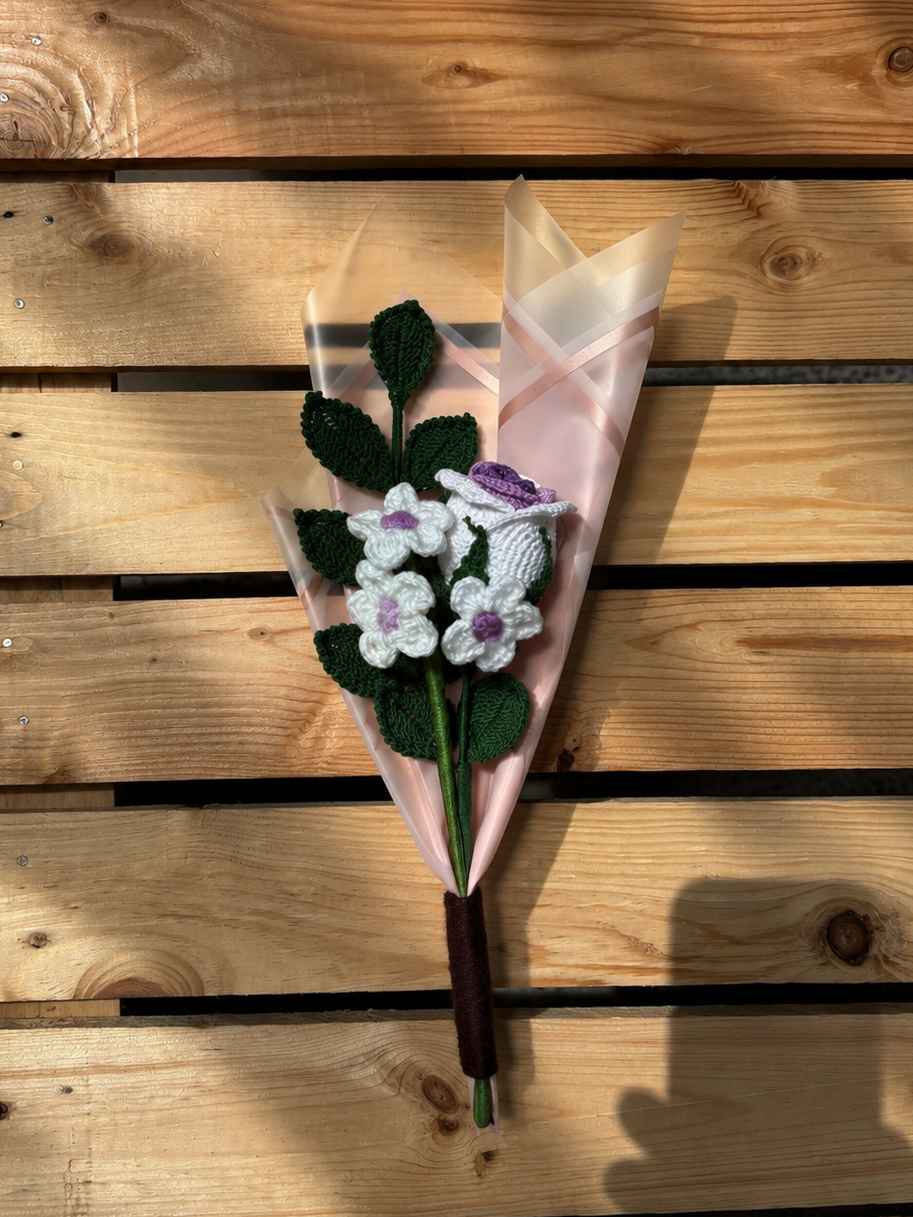 Knitted flower bouquet on a wooden surface